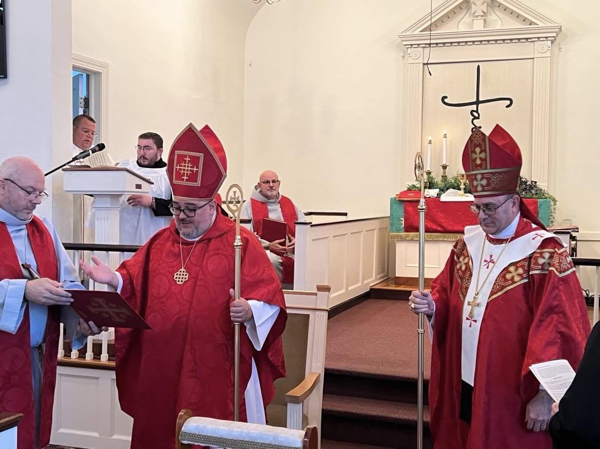 Bishop in red vestments and mitre with crozier during liturgy